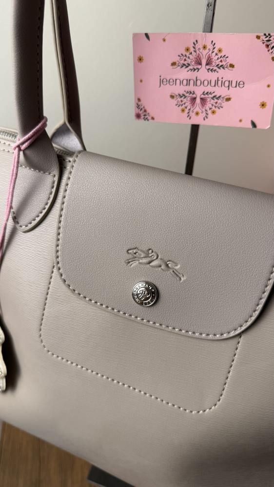 Long champagne-colored leather bag