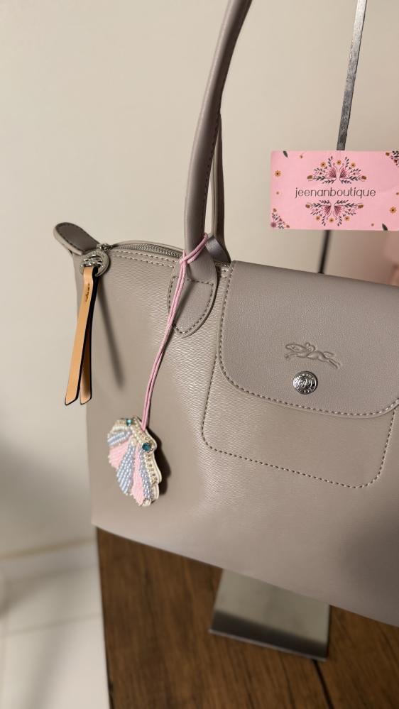 Long champagne-colored leather bag