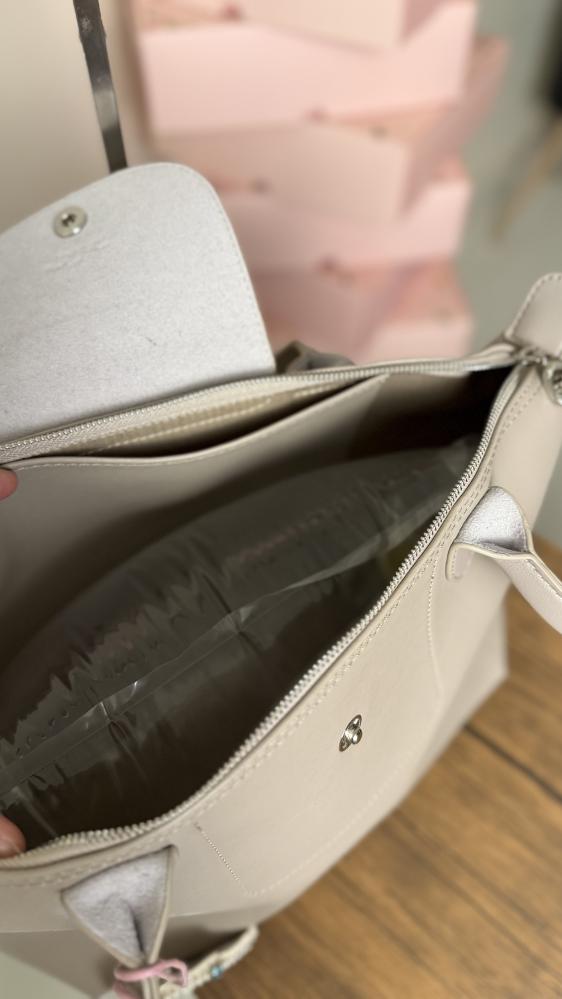 Long champagne-colored leather bag