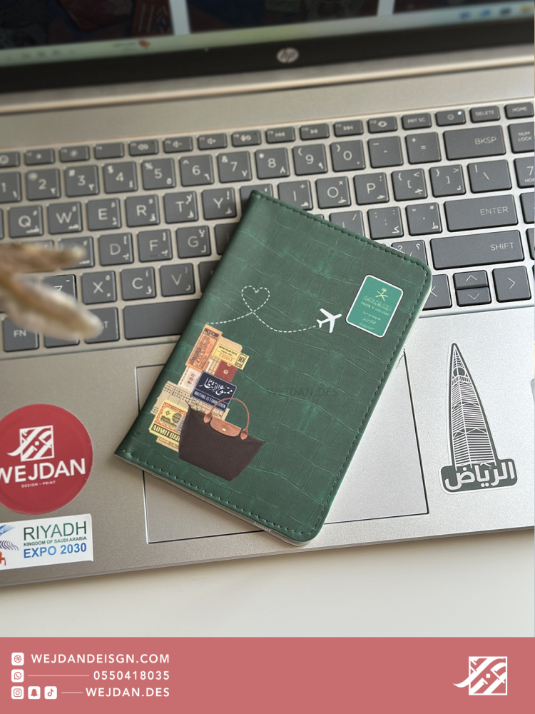 Green passport cover with stickers.