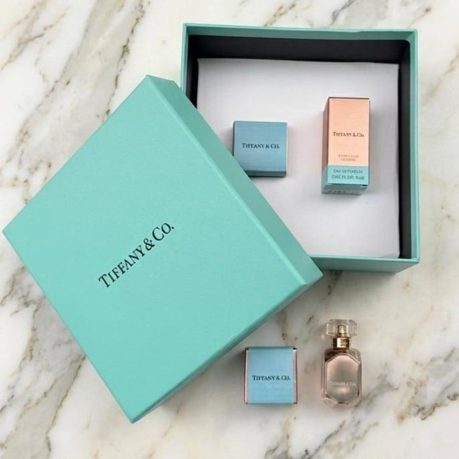 5 Tiffany boxes containing Tiffany perfume and a piece of chocolate