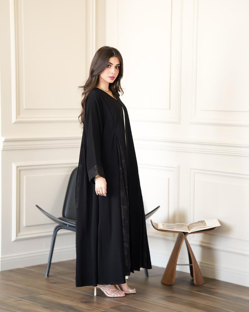 عباية نسائية سوداء مفتوحة بتصميم كلوش واسع وتفاصيل دانتيل جاكار مزخرف على الجوانب والأكمام | عبايات فاخرة للمناسبات والخروج