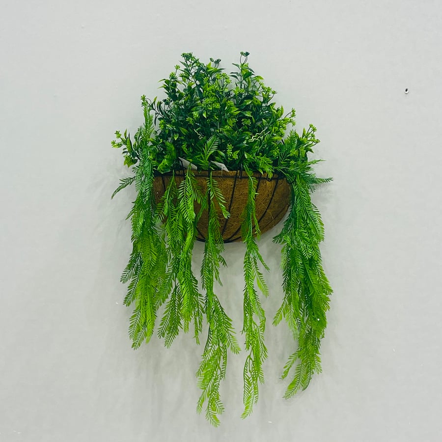 Artificial tree with coconut shell hanging on the wall