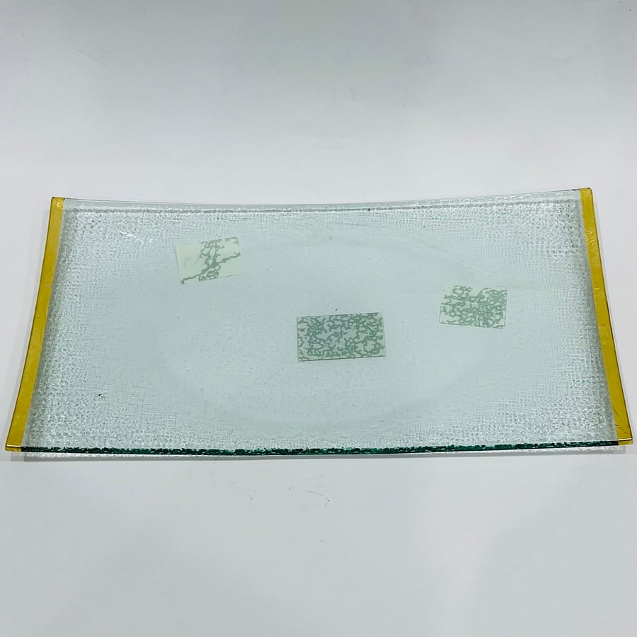 A curved glass plate with gold edges, size 33*17 cm