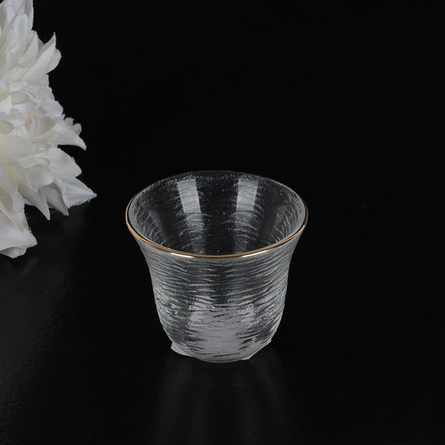 A cold glass cup with gold