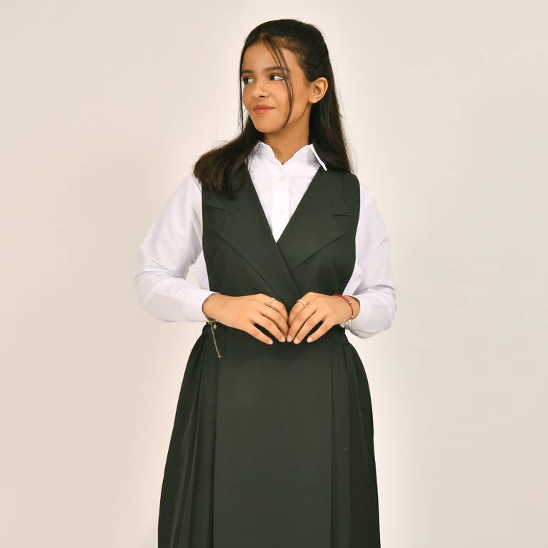 Olive green apron with a blazer collar and pleats on the sides
