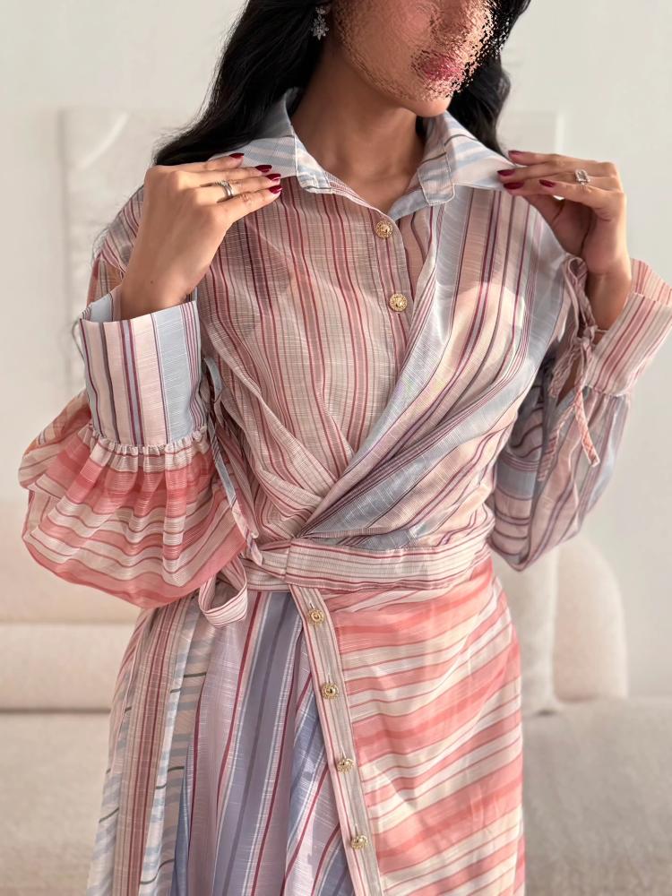 A shirt-style dress made of pastel-colored striped fabric
