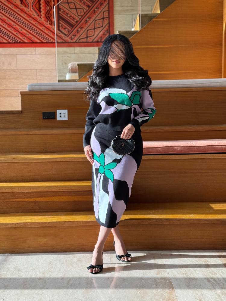 A two-piece set of a sweater and a skirt with a distinctive print