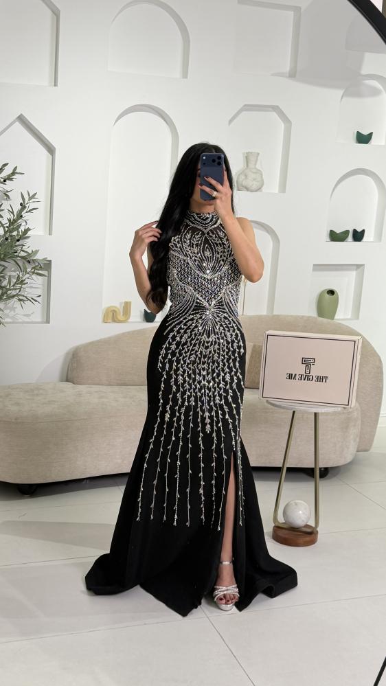 Black evening dress embroidered with a side slit