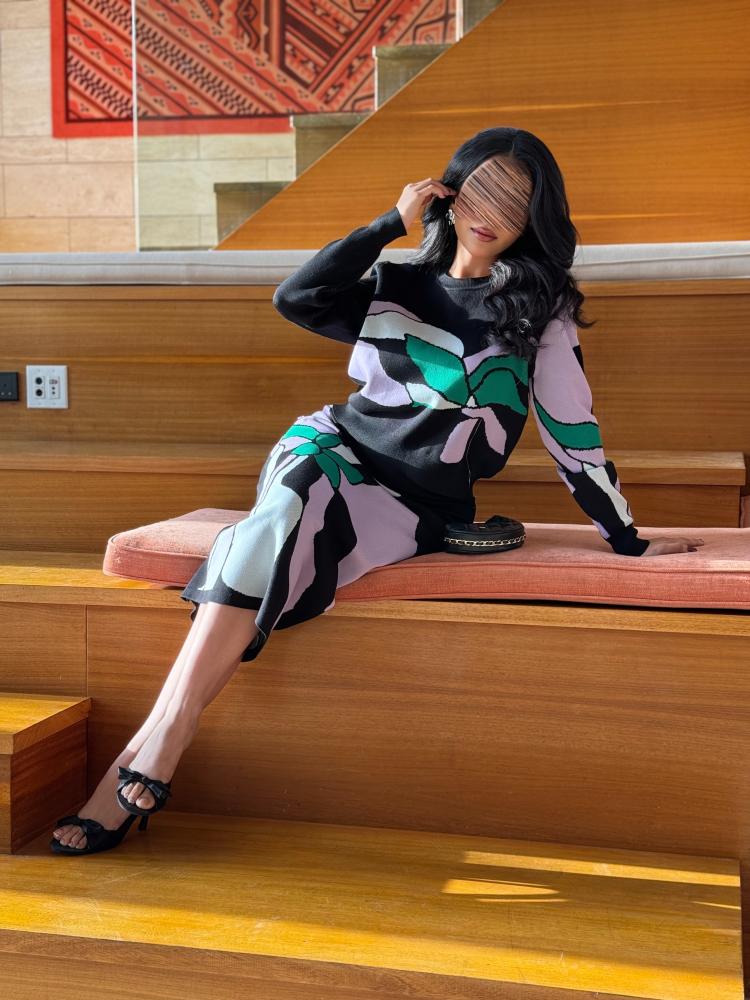 A two-piece set of a sweater and a skirt with a distinctive print