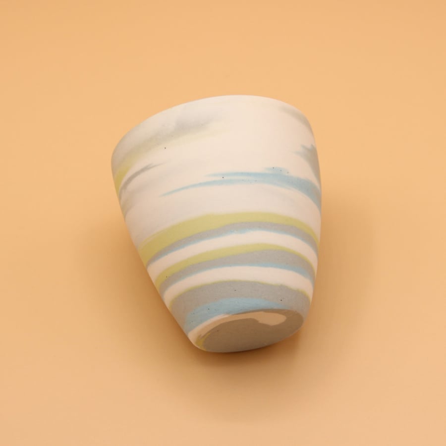 A yellow cup with different ripples
