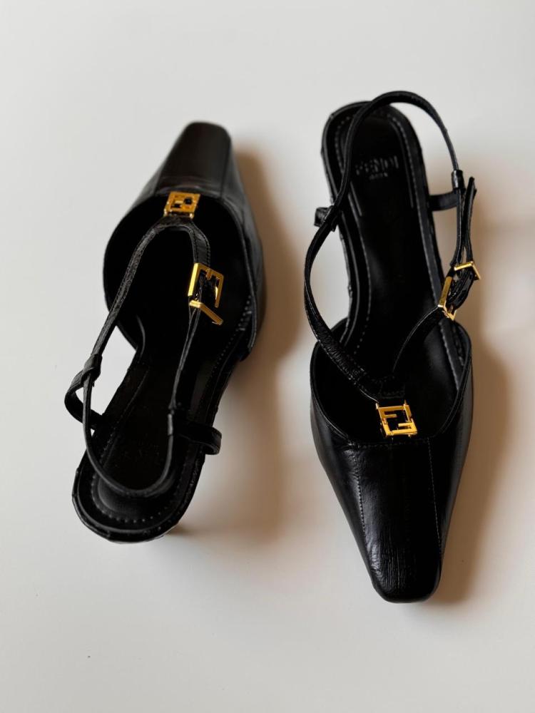 Black luxury flip-flop with a back strap, fold design, and low heel