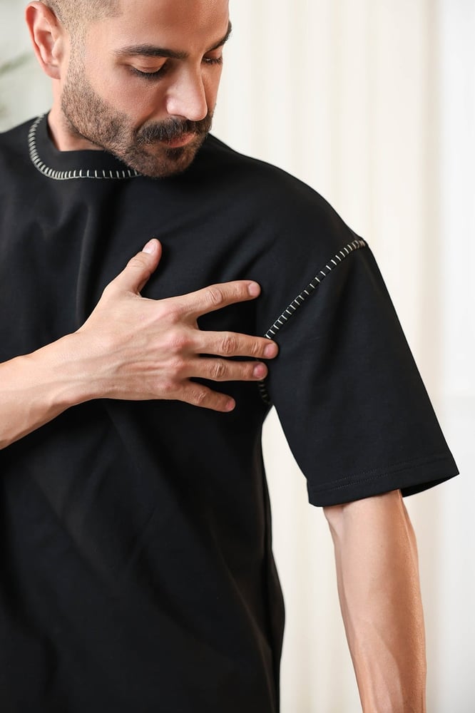 Men's oversized set, short sleeves, long pants, round collar decorated with colorful stitches on the T-shirt and the pants