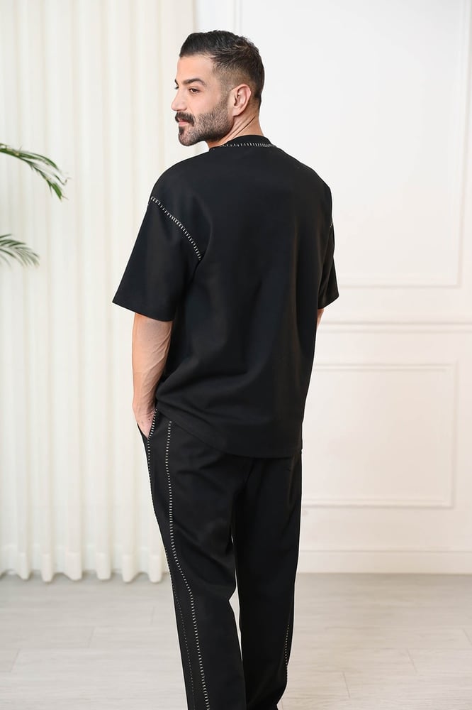Men's oversized set, short sleeves, long pants, round collar decorated with colorful stitches on the T-shirt and the pants