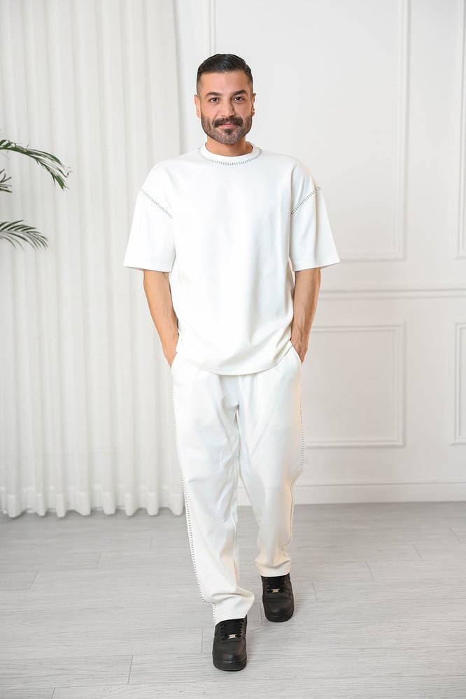 Men's oversized set, short sleeves, long pants, round collar decorated with colorful stitches on the T-shirt and the pants