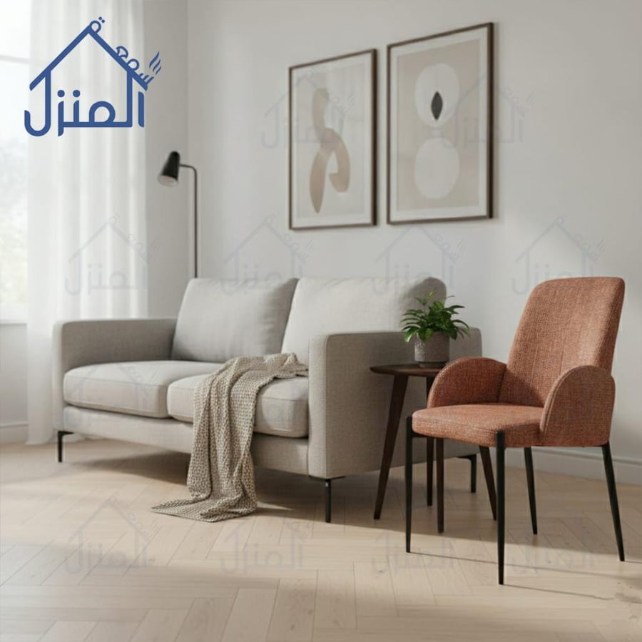 كرسي مودرن بقماش برتقالي محروق وقاعدة معدنية سوداء  فاخر ومساند ذراعين