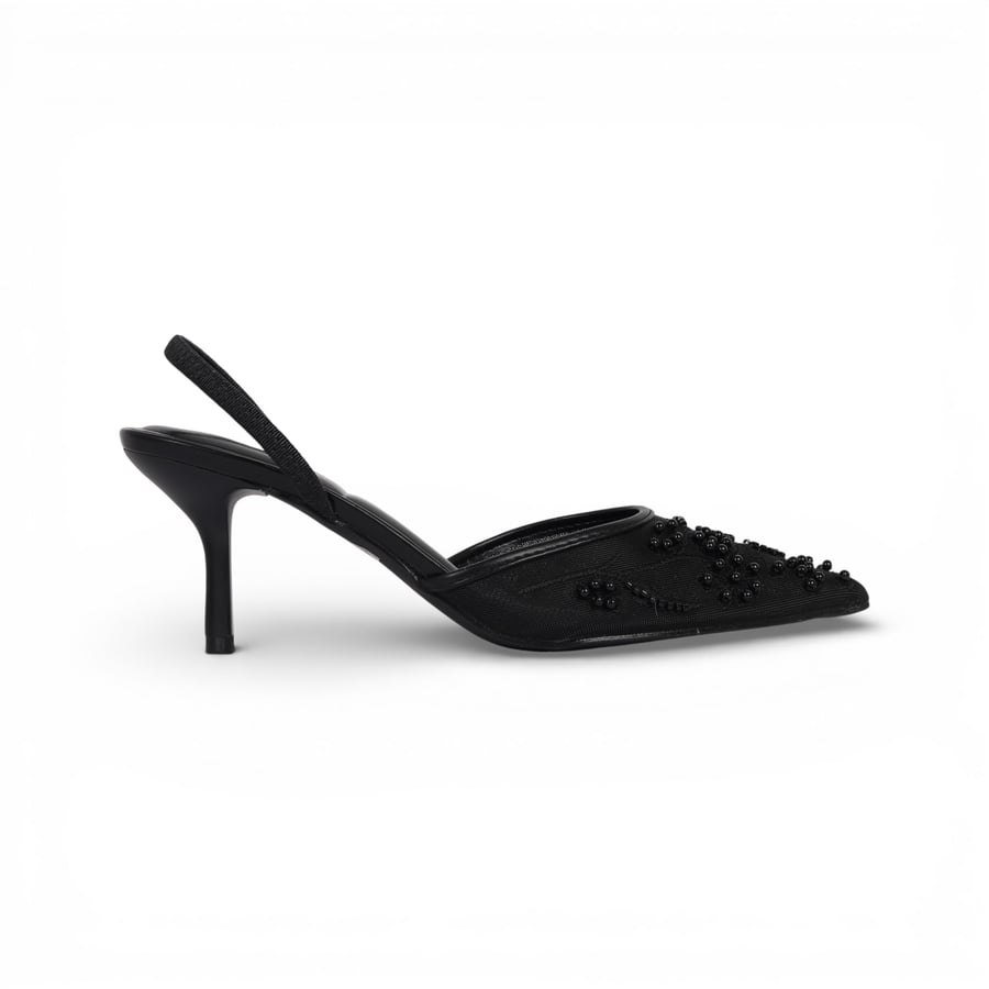 The shoes are decorated with pearls, with a spike heel from Madeleine, black.