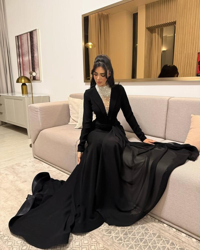 فستان سهرة أسود بأكمام طويلة وتفاصيل فضية
