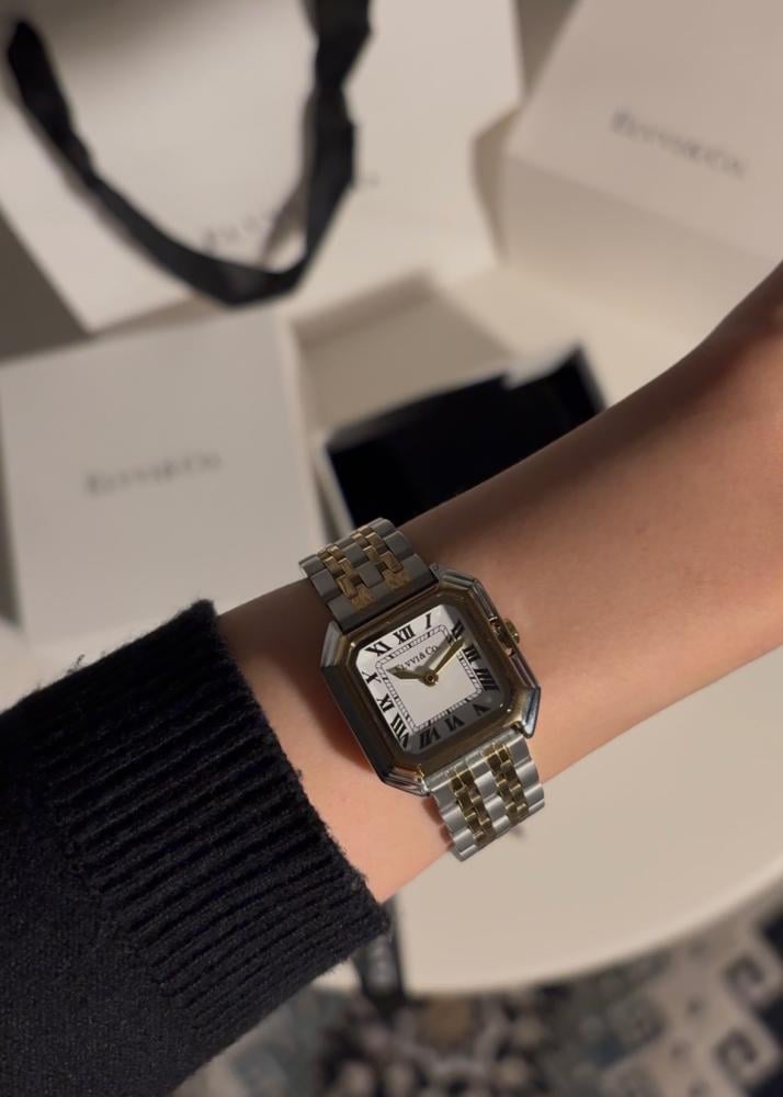 A gift containing a bouquet of 25 roses with a watch