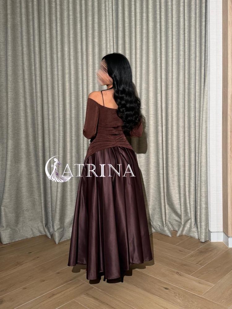 A brown evening dress with an off-shoulder design and elegant metallic details