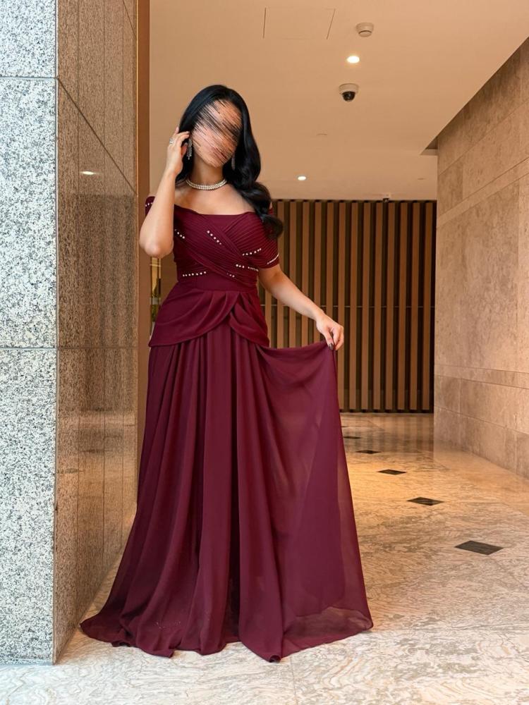 Maroon off-shoulder dress decorated with shiny rhinestones