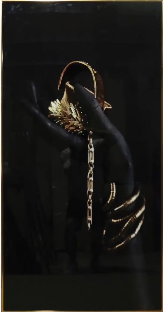 A black artistic painting with a golden frame