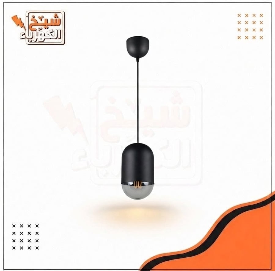 وحدة إضاءة معلقة (سلندر) سقفية بتصميم أسطواني قصير وعصري بلون أسود مطفي مع جزء سفلي زجاجي مدخن شفاف يكشف عن لمبة ليد ديكورية دافئة، مُعلقة بسلك متين تتصل بقاعدة سقفية دائرية، لتمنح إضاءة ناعمة وموزعة تعكس هوية معمارية راقية وتلبي احتياجات الإضاءة الحديثة