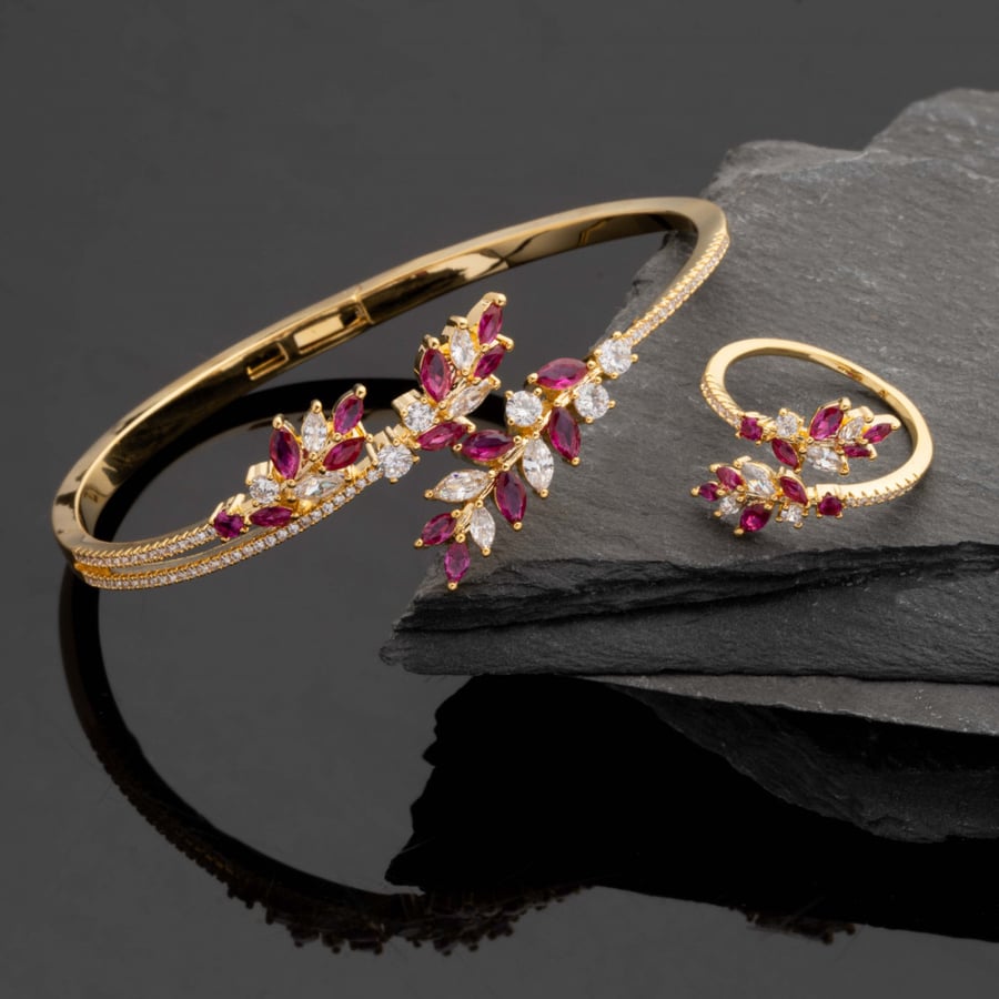 A ring and a fancy gold and red ring