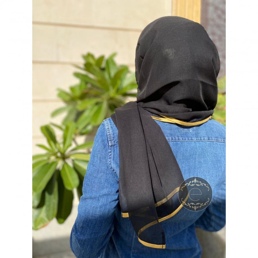 A Bawal headscarf with a gold ribbon
