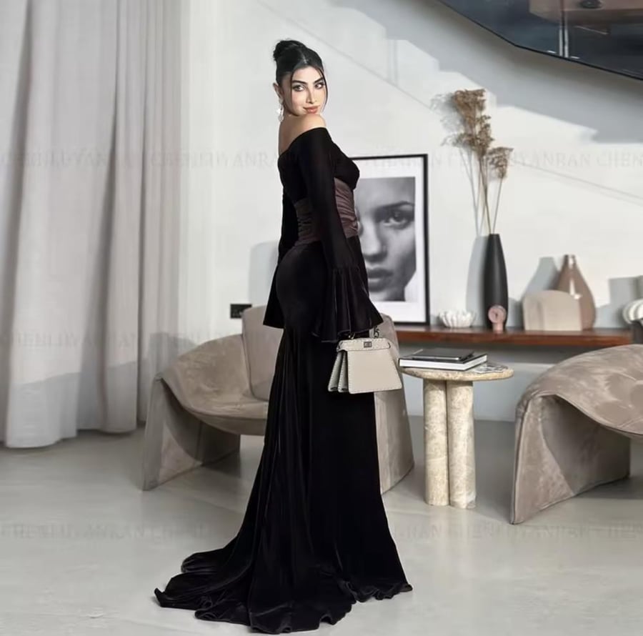 Elegant evening dress made of velvet with long sleeves and a boat-shaped neckline opening