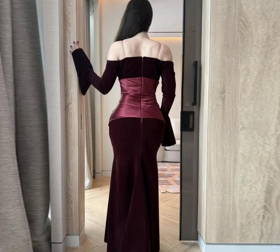 Elegant evening dress made of velvet with long sleeves and a boat-shaped neckline opening