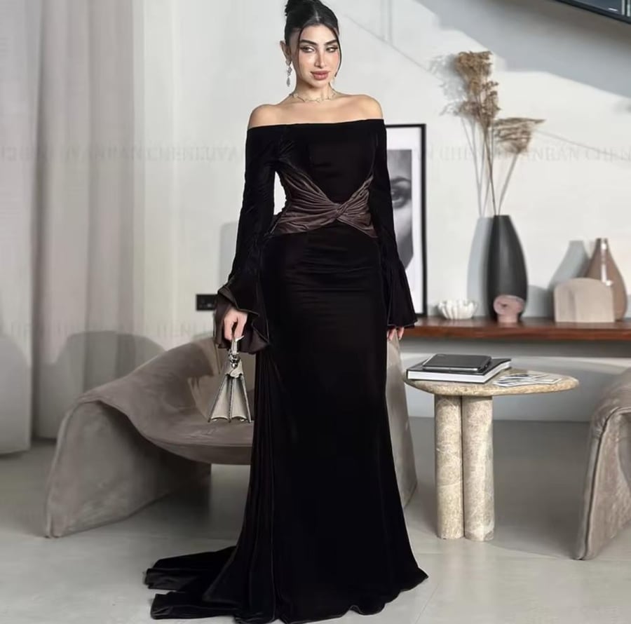 Elegant evening dress made of velvet with long sleeves and a boat-shaped neckline opening