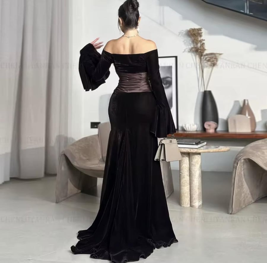 Elegant evening dress made of velvet with long sleeves and a boat-shaped neckline opening