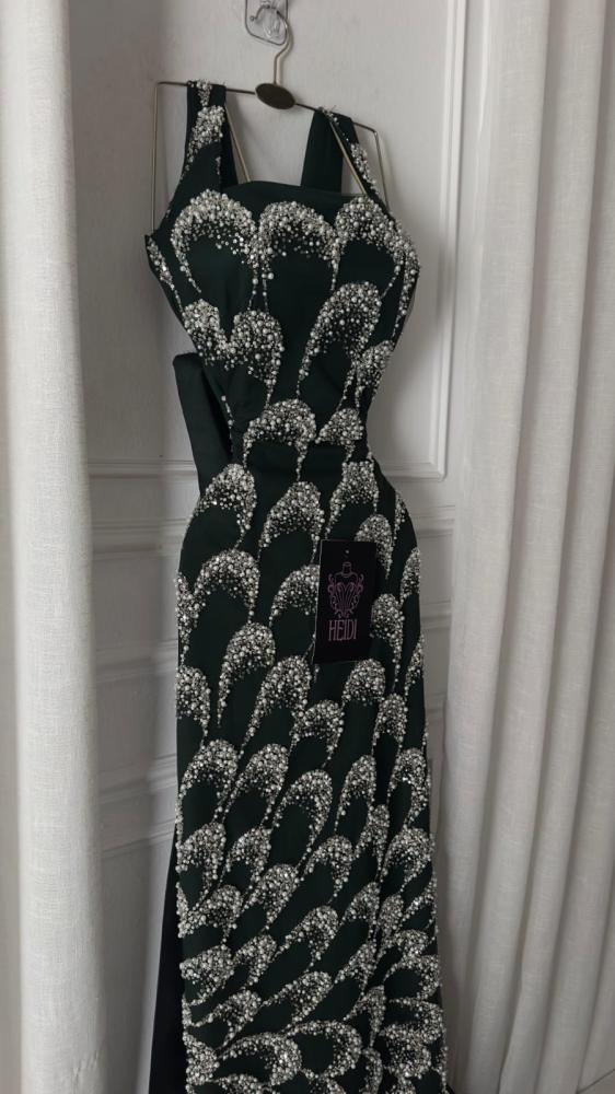 Create an elegant evening dress in olive green embroidered with luxurious silver beads