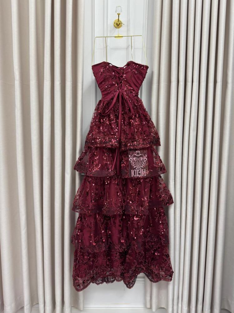 Secrets of an orange evening dress with layered embroidery and shiny sequins