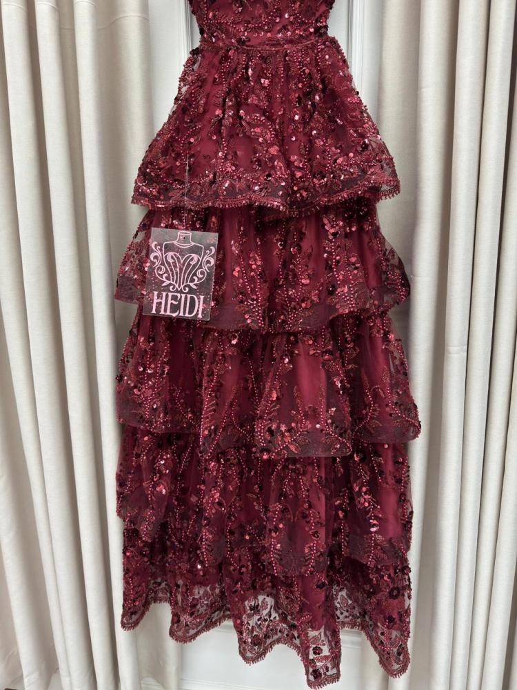 Secrets of an orange evening dress with layered embroidery and shiny sequins