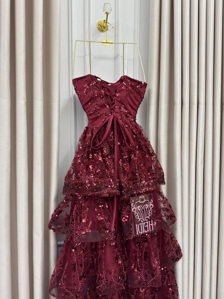 Secrets of an orange evening dress with layered embroidery and shiny sequins