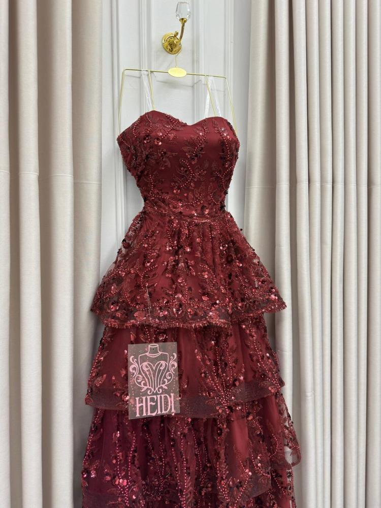 Secrets of an orange evening dress with layered embroidery and shiny sequins