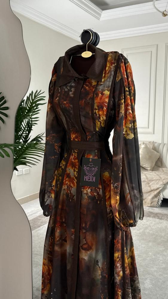 A maxi dress with a floral pattern in warm autumn colors and a formal collar