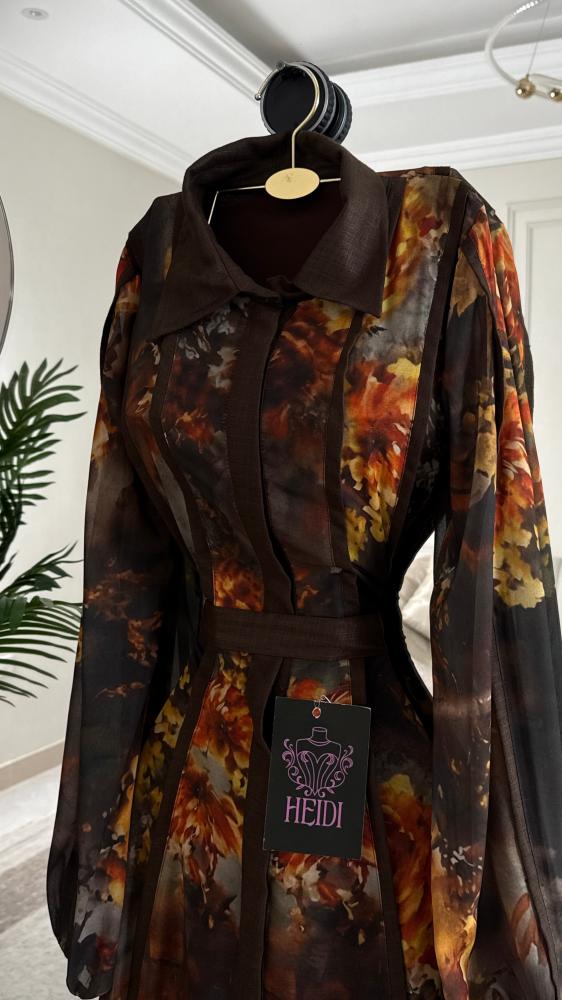 A maxi dress with a floral pattern in warm autumn colors and a formal collar