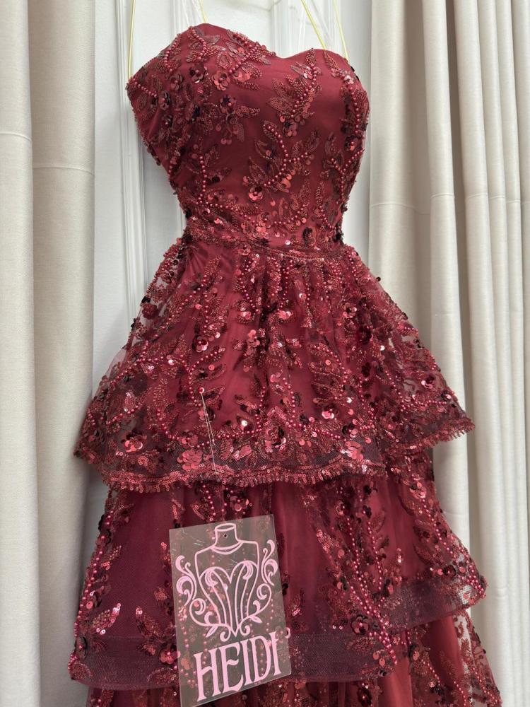 Secrets of an orange evening dress with layered embroidery and shiny sequins