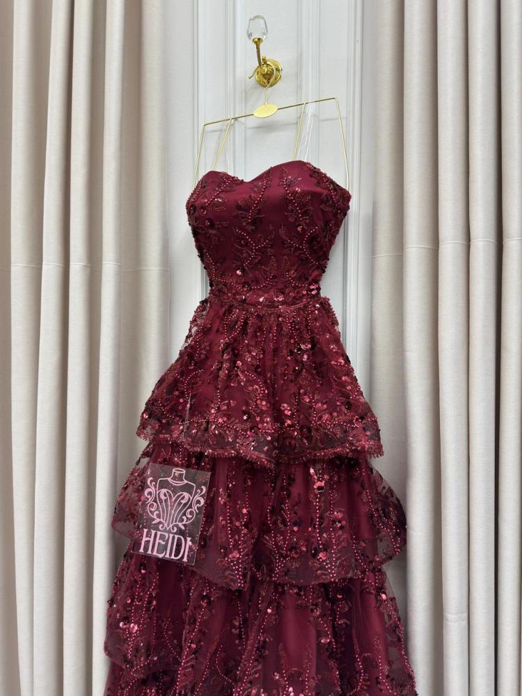 Secrets of an orange evening dress with layered embroidery and shiny sequins