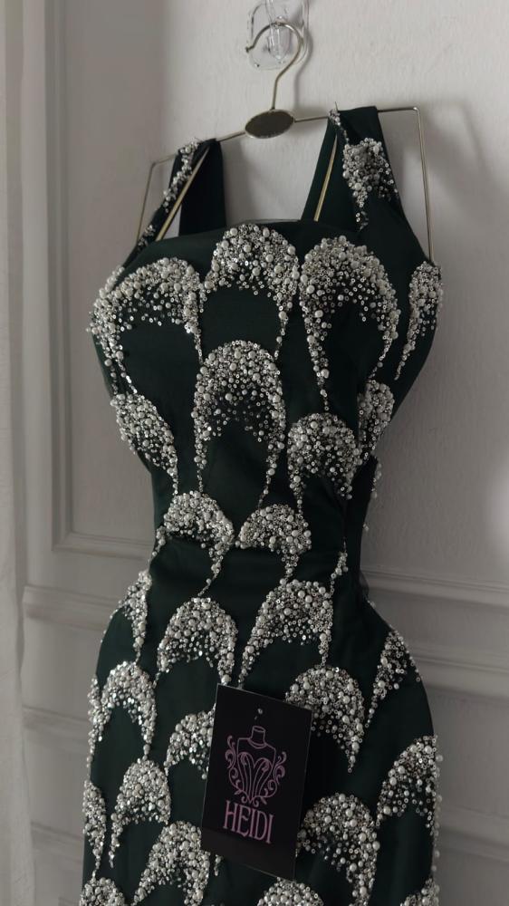Create an elegant evening dress in olive green embroidered with luxurious silver beads