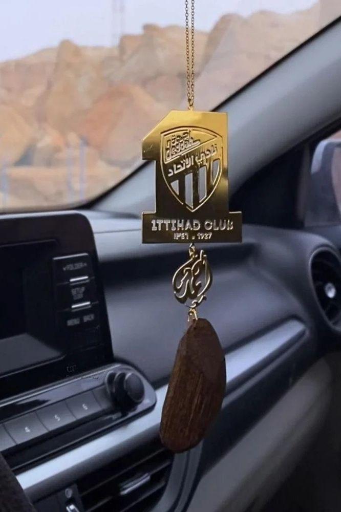 Car pendant with the name and the logo of Al Ittihad Club and oud incense
