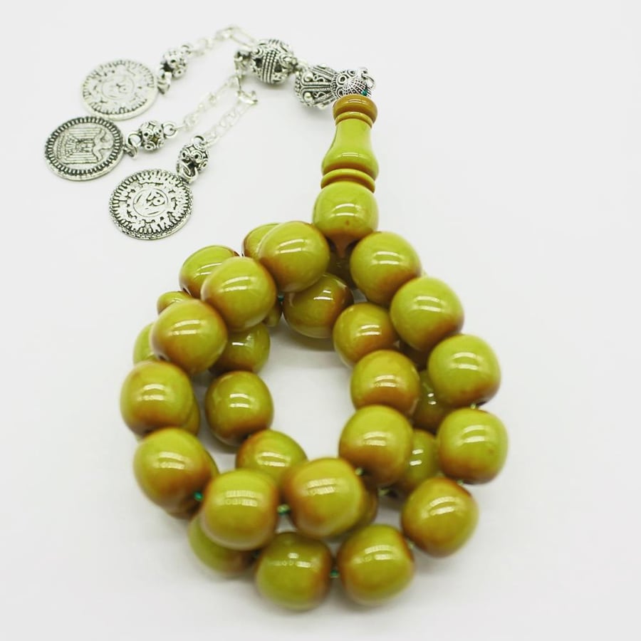 Green musk prayer beads with an oily finish, round beads, and an antique tassel