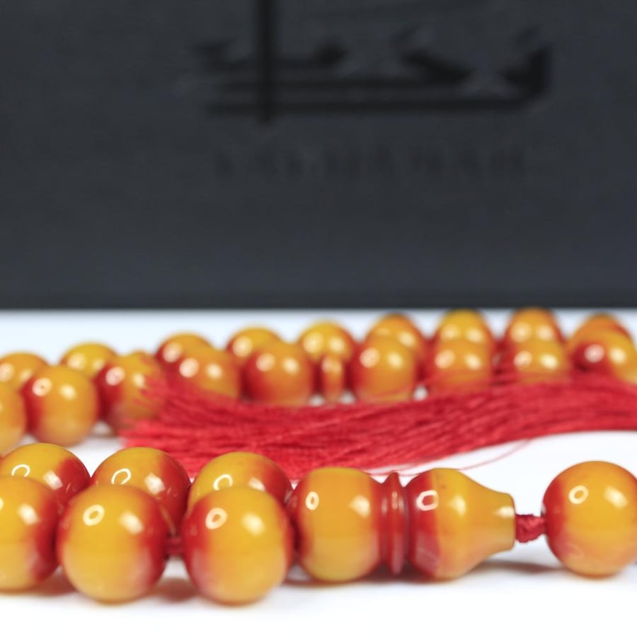 A musk prayer bead with a honey yellow color and round beads