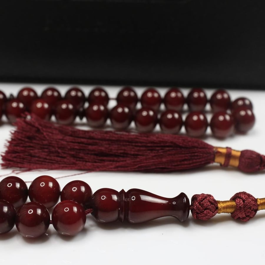 A rosary with crystal coral mixed with brown