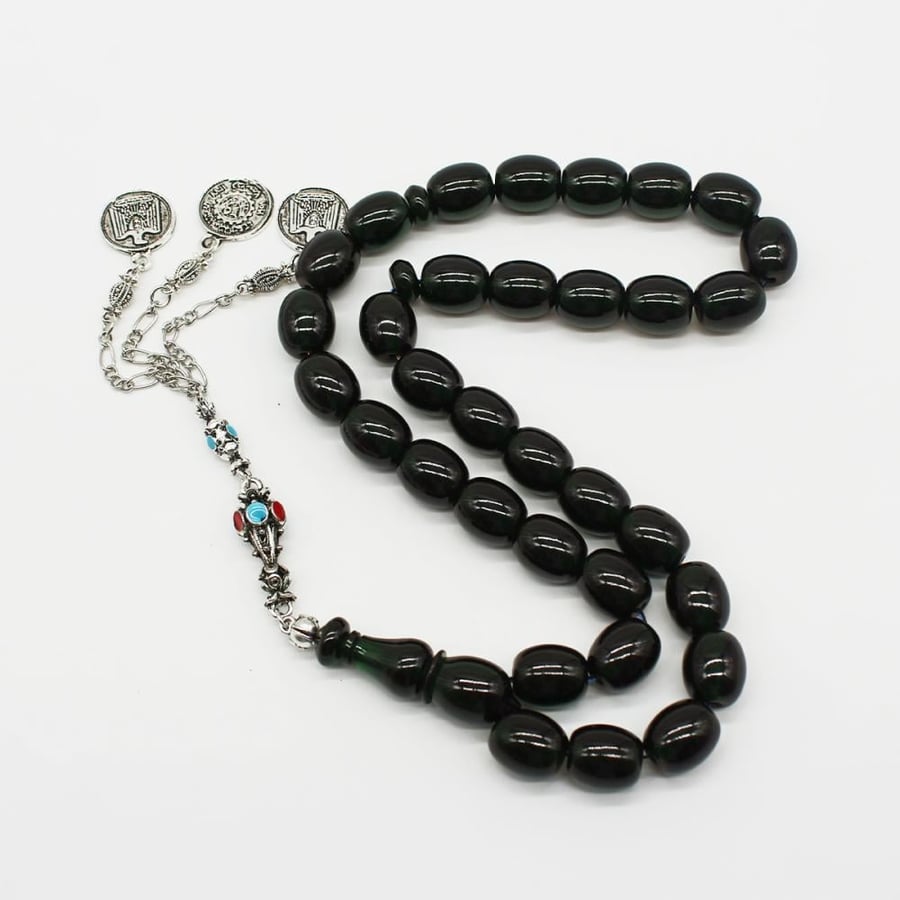 A dark green musk prayer bead with cylindrical beads and a traditional tassel