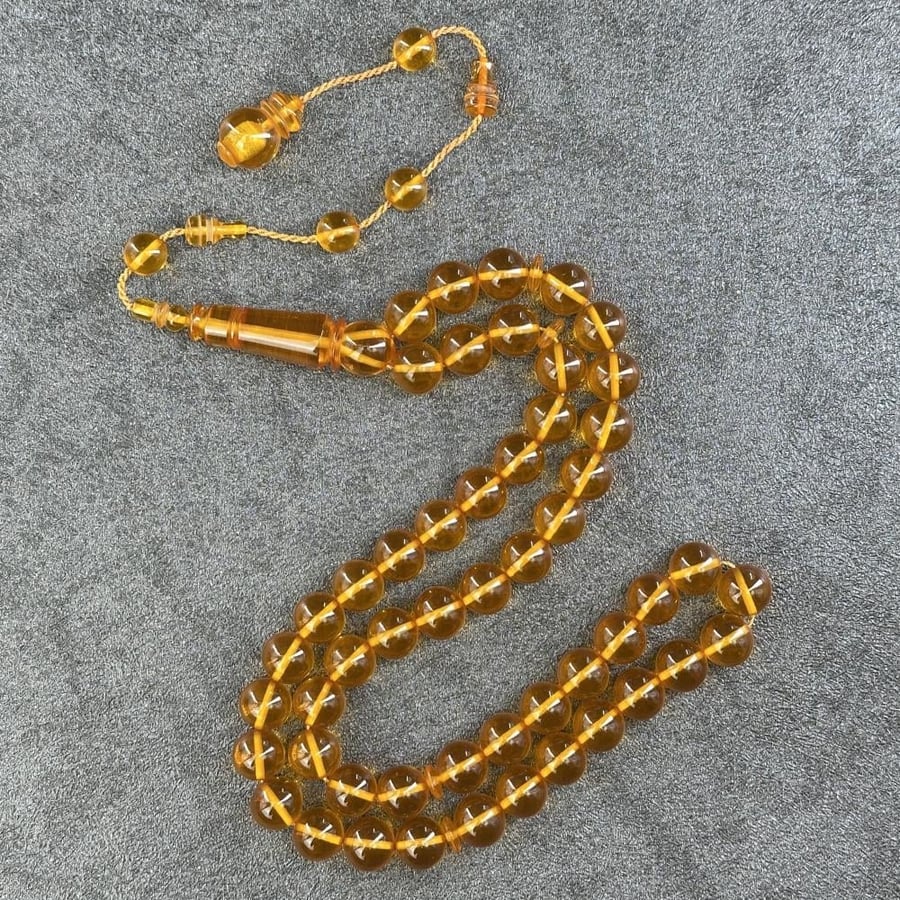 Yellow saffron-colored transparent prayer bead