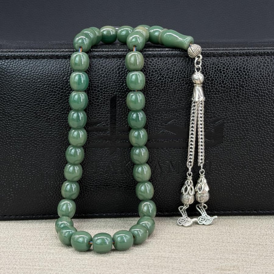 Green-colored beaded prayer bead, tassel